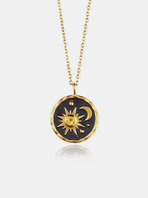 Gold celestial medallion pendant necklace with sun, moon, and zircon detail on a fine chain.