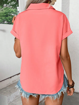 Coral polyester button-down shirt with cuffed short sleeves and a curved hem.