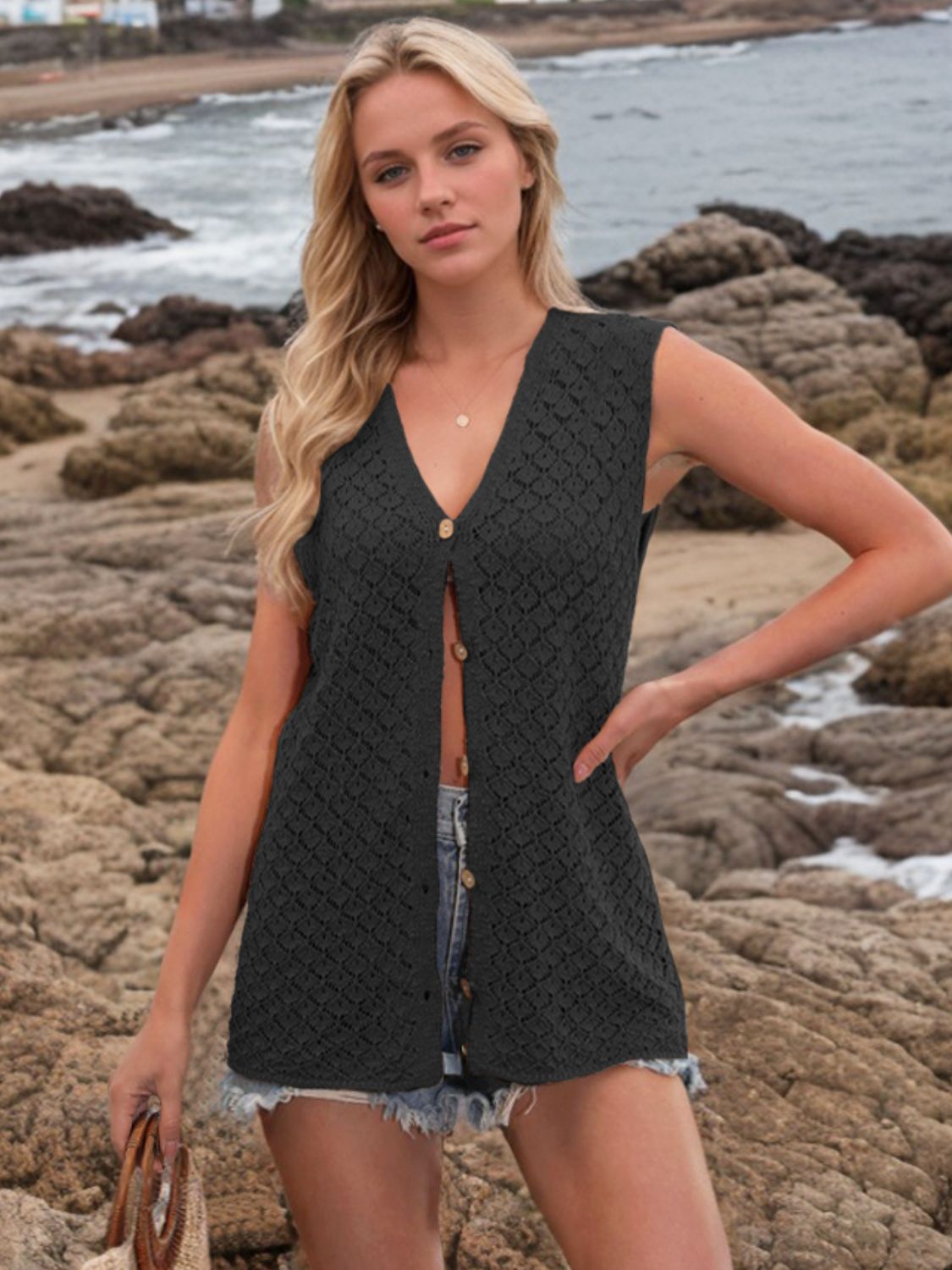 Black openwork button-down knit vest with a V-neck and wooden buttons.