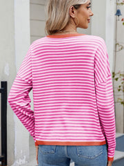 Fuchsia pink striped drop shoulder knit sweater with contrast trim neckline and hem.