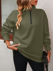 Army green quarter-zip relaxed fit sweatshirt with a mock neck and black zipper detail.