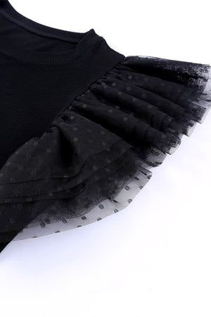 Black ribbed knit blouse with ruffled dot mesh sleeves.