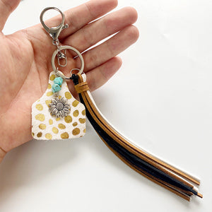 Leopard print tag keychain with flower charm, turquoise beads, and multi-color tassels.
