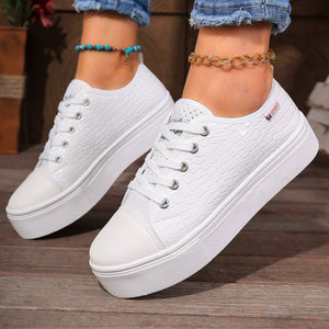 White crocodile embossed platform sneakers with a chunky sole.