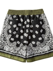 Black bandana print sport shorts with green waistband and metallic trim detail.