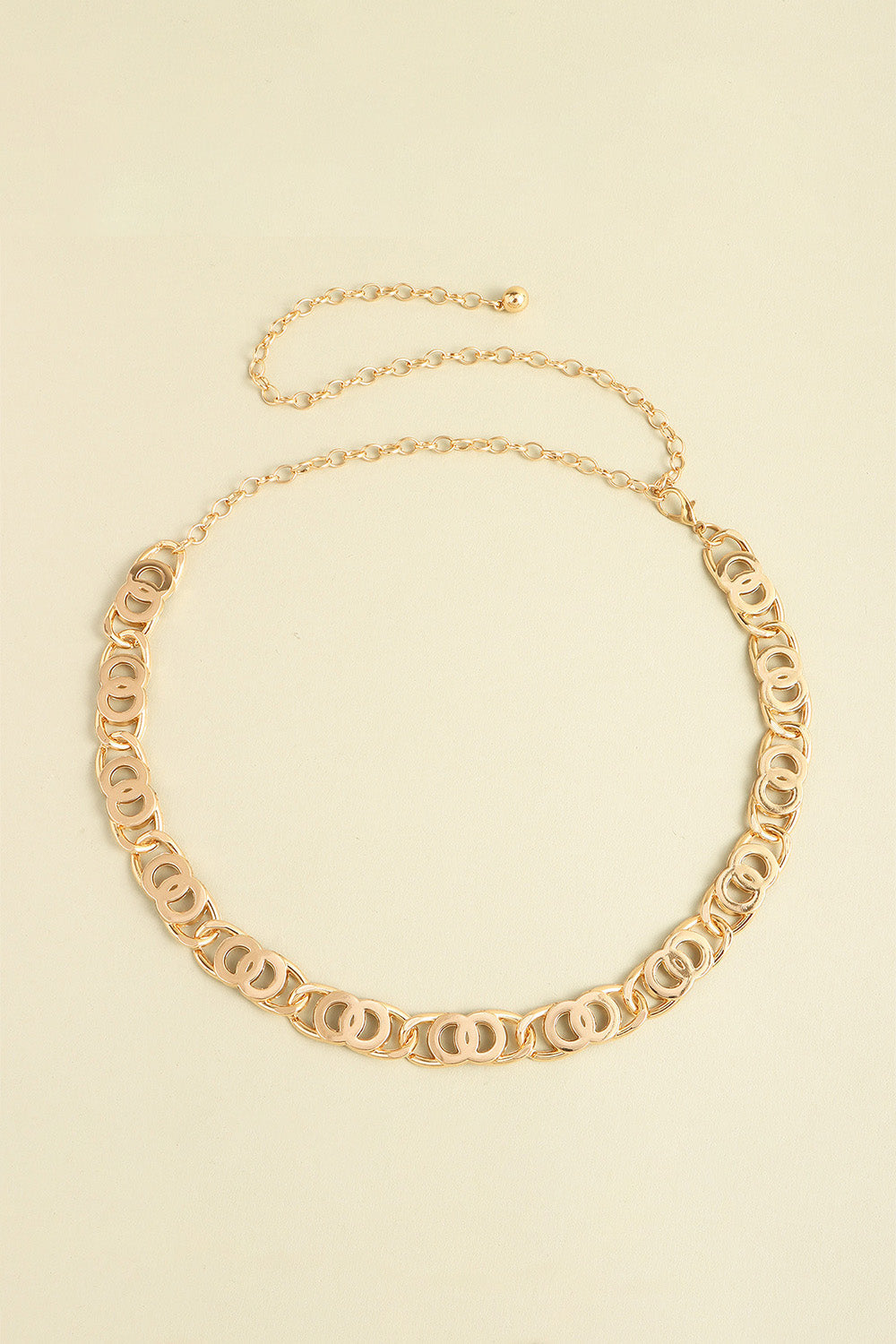 Golden chain belt with interlocking circle links and adjustable extender chain.