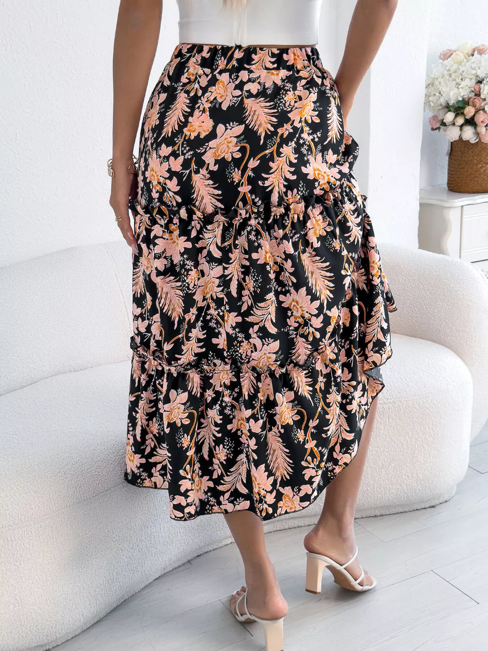 Black floral midi skirt with ruffle hem and drawstring waist.