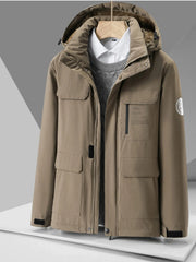 Khaki hooded puffer jacket with multiple pockets and faux fur lined hood.