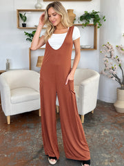 Brown wide-leg pocket jumpsuit with deep V-neck and white tee.