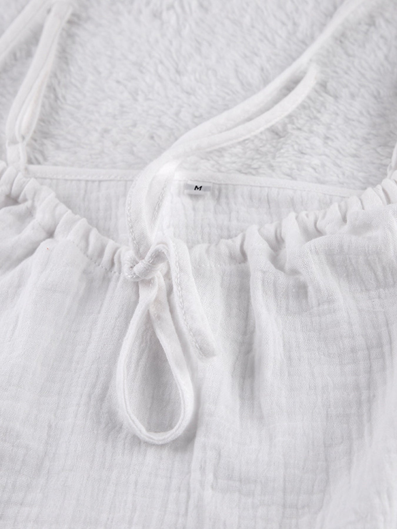 White cotton cami pajama top with adjustable tie detail and spaghetti straps
