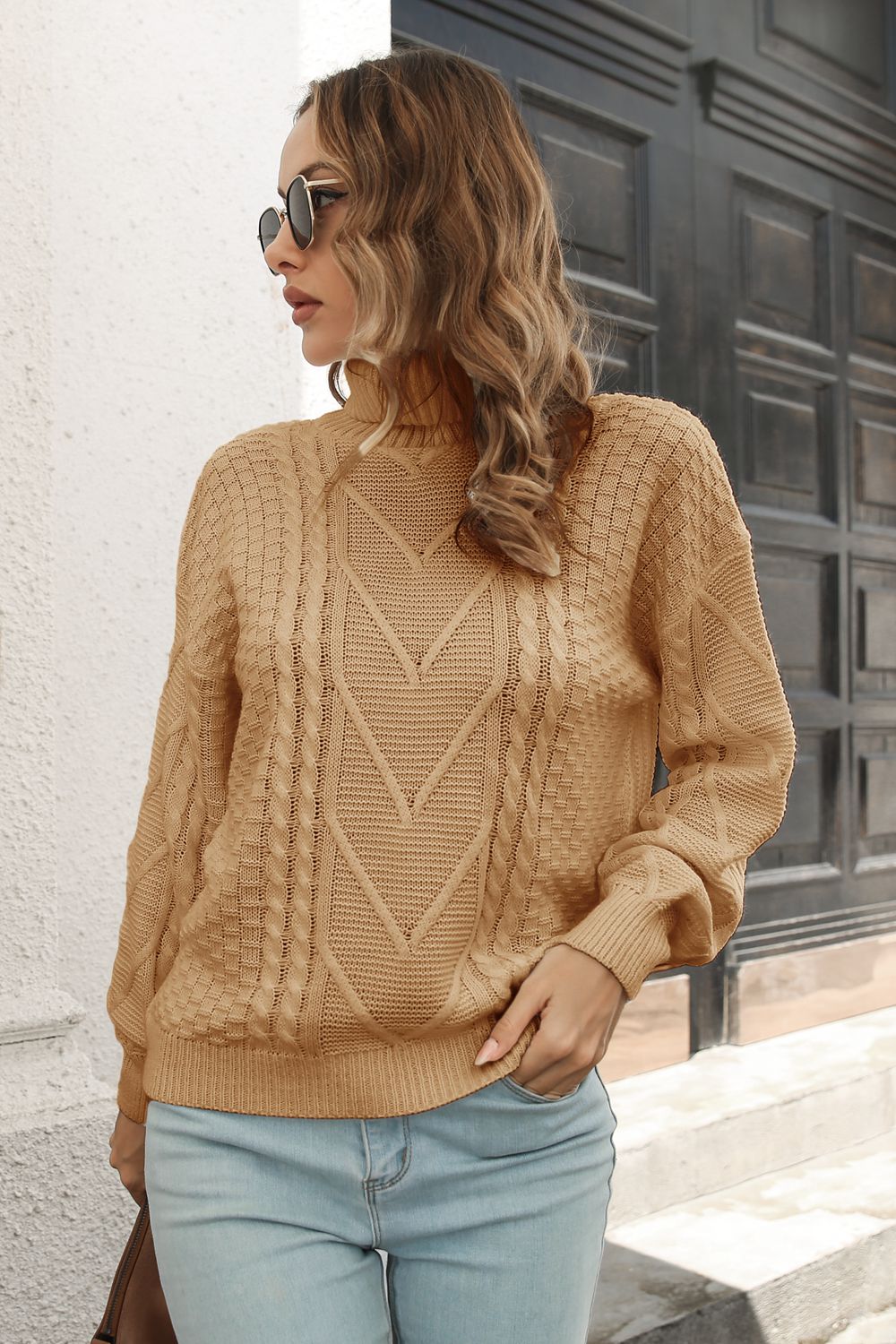 Camel cable knit turtleneck sweater with chevron pattern and acrylic material.