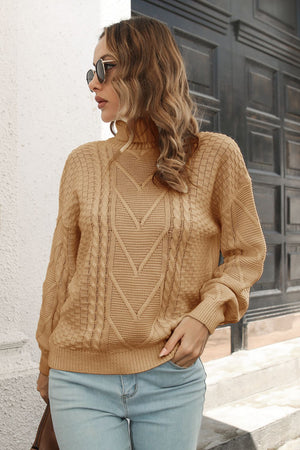 Camel cable knit turtleneck sweater with chevron pattern and acrylic material.