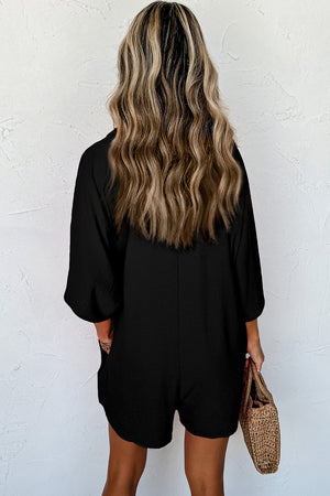 Black oversized shirt romper with pockets and 3/4 sleeves.