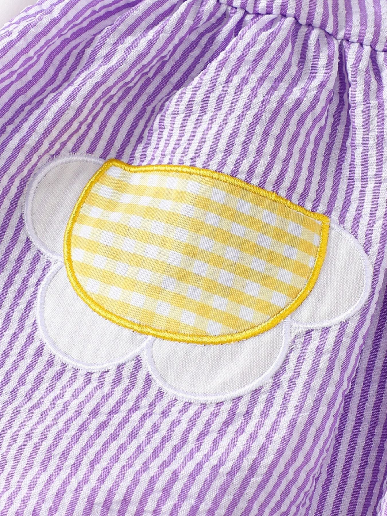 Children's purple and white striped seersucker top with a yellow gingham flower applique.