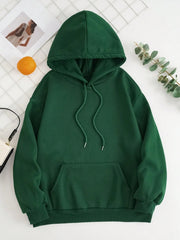 Dark green oversized hoodie with pouch pocket and drawstring hood.