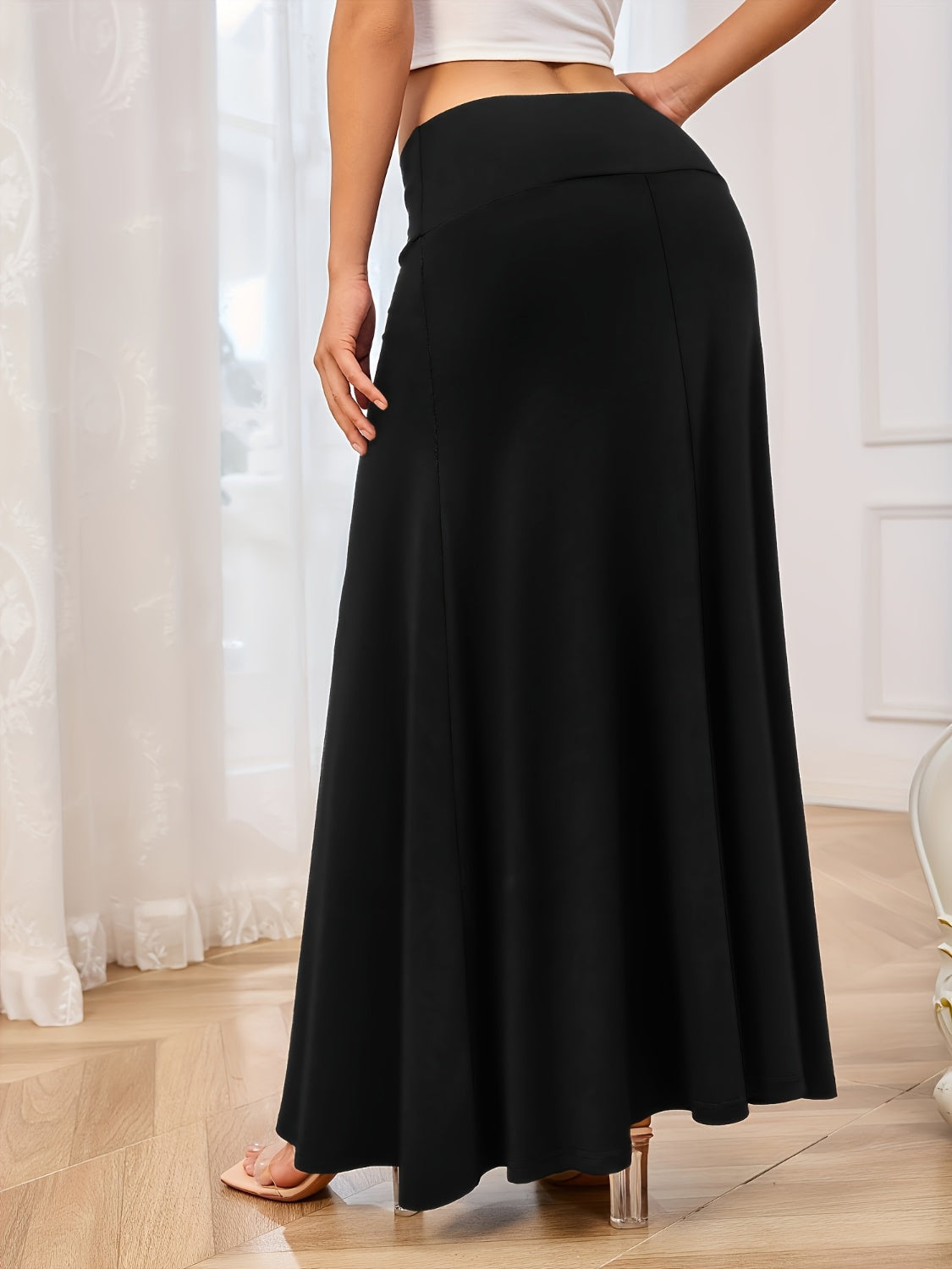 Flowing jersey maxi skirt in black with a wide waistband and A-line cut.