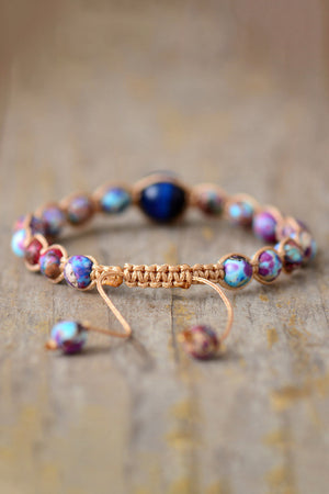 Bohemian multicolor jasper beadwork bracelet with adjustable macrame cord and a central blue bead.