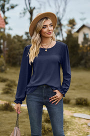 Dark Navy waffle knit blouse with perforated yoke and ruffled cuffs.