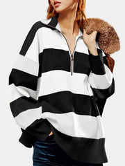 Oversized black and white striped zip-up pullover with a collared neckline.