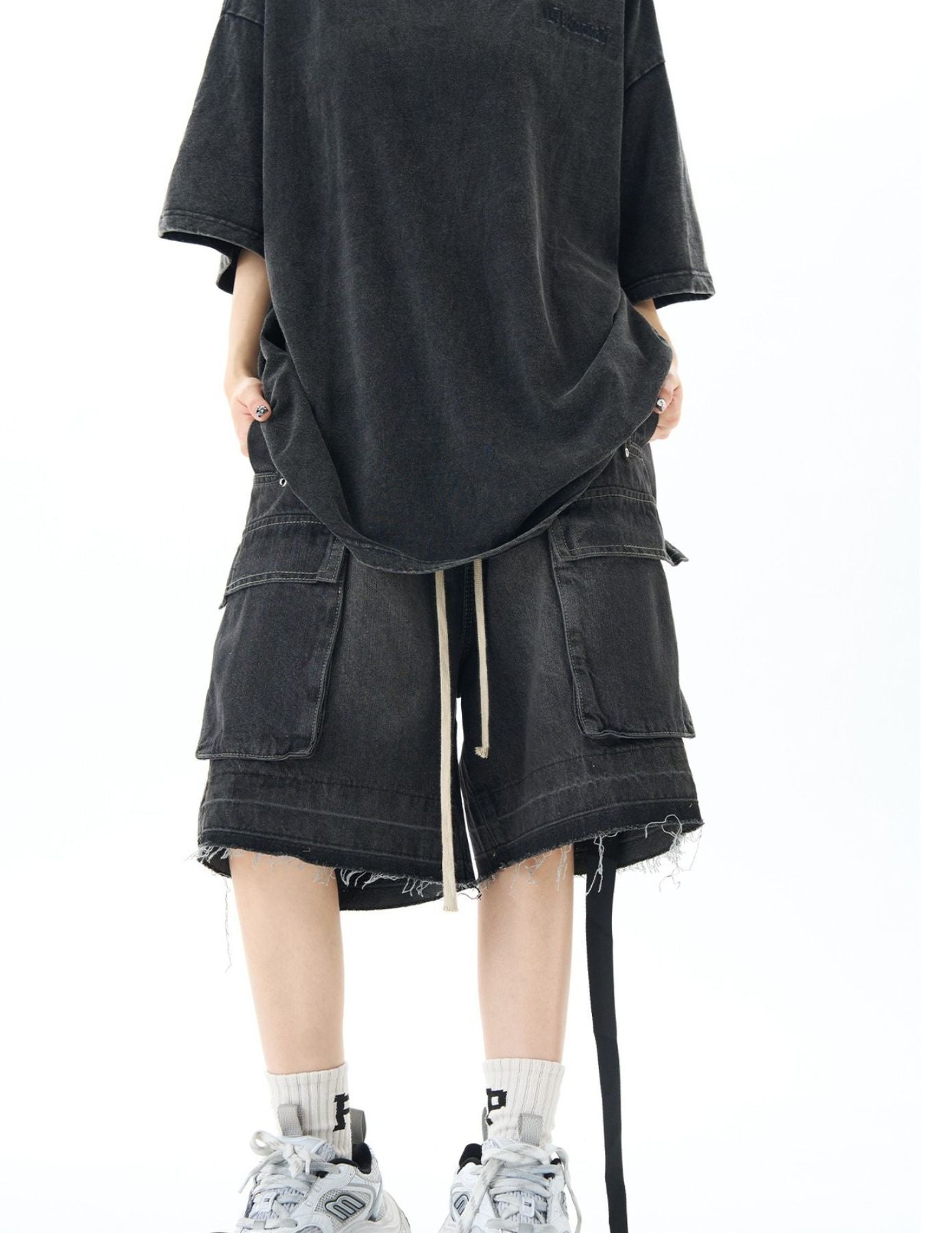 Black vintage cargo denim shorts with frayed hem and drawstring waist.