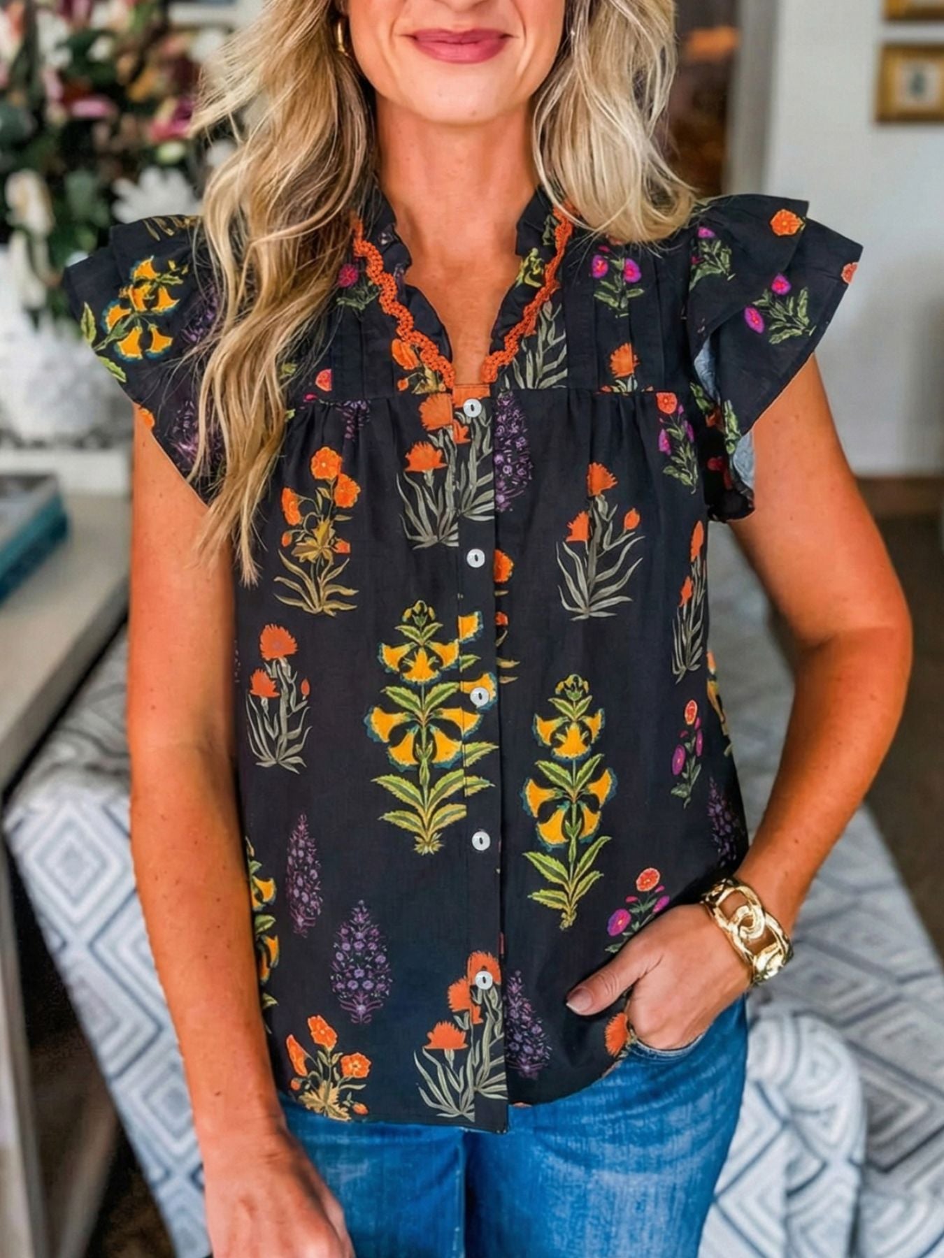 Black floral print maternity shirt with V-neck, frill detail, and short flutter sleeves.