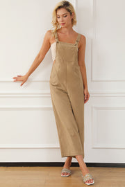 Tan corduroy overalls with wide leg silhouette and buttoned straps.