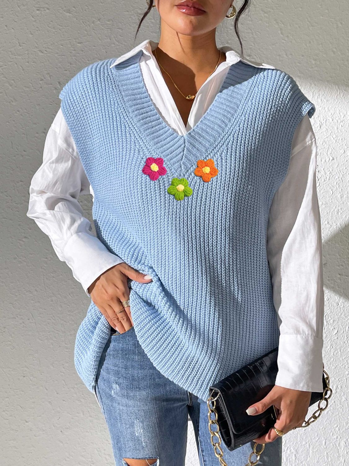 Light blue ribbed knit vest with embroidered flowers, V-neck, sleeveless, acrylic.