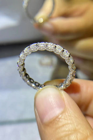 Eternity band ring in silver with full circle of sparkling moissanite stones.