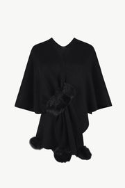 Black knit cape with fur trim detail at the front and hem.