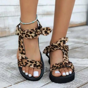 Bow-Tie Platform Sandals in Leopard with ankle straps and bows.