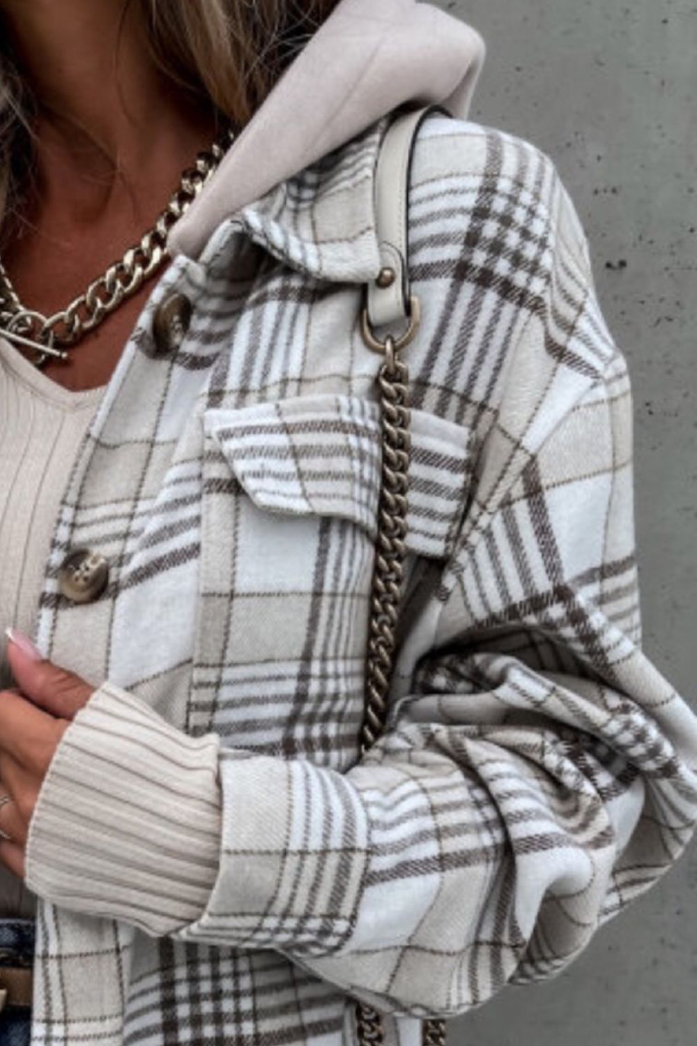 Oversized plaid shacket in camel with a hood detail and buttoned pockets.