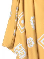 Yellow midi dress with geometric print, 3/4 sleeves, and notched neckline detail.