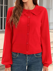 Red knit cardigan with scalloped collar, button front, and balloon sleeves.