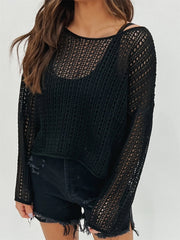 Black open-knit slouchy sweater with crew neck and long sleeves, styled with a cami and distressed shorts.