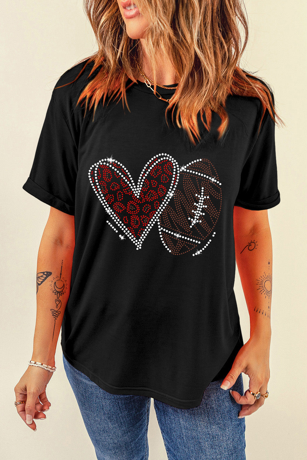 Black t-shirt with rhinestone heart and football graphic detail