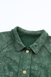 Green washed cotton utility jacket with distressed details and brass buttons.