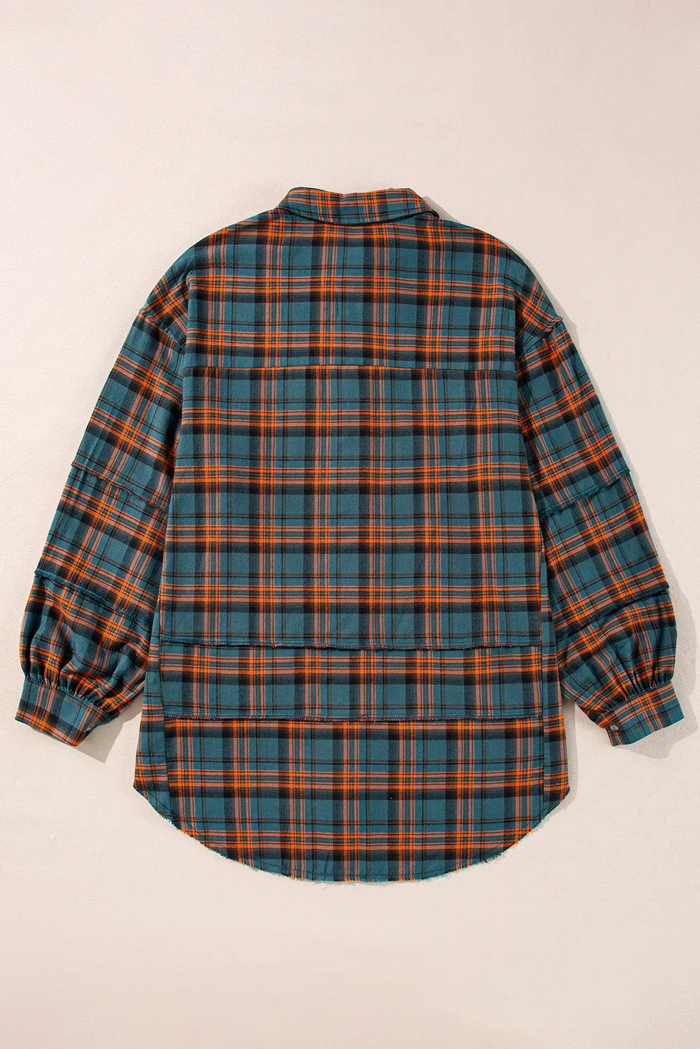 Oversized plaid overshirt in French blue with layered hem detail and cuffed sleeves.
