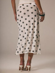 Classic polka dot midi skirt in white with black dots, featuring a flowy silhouette and sheer fabric.