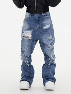 Distressed baggy fit men's blue denim jeans with rips and frayed details.