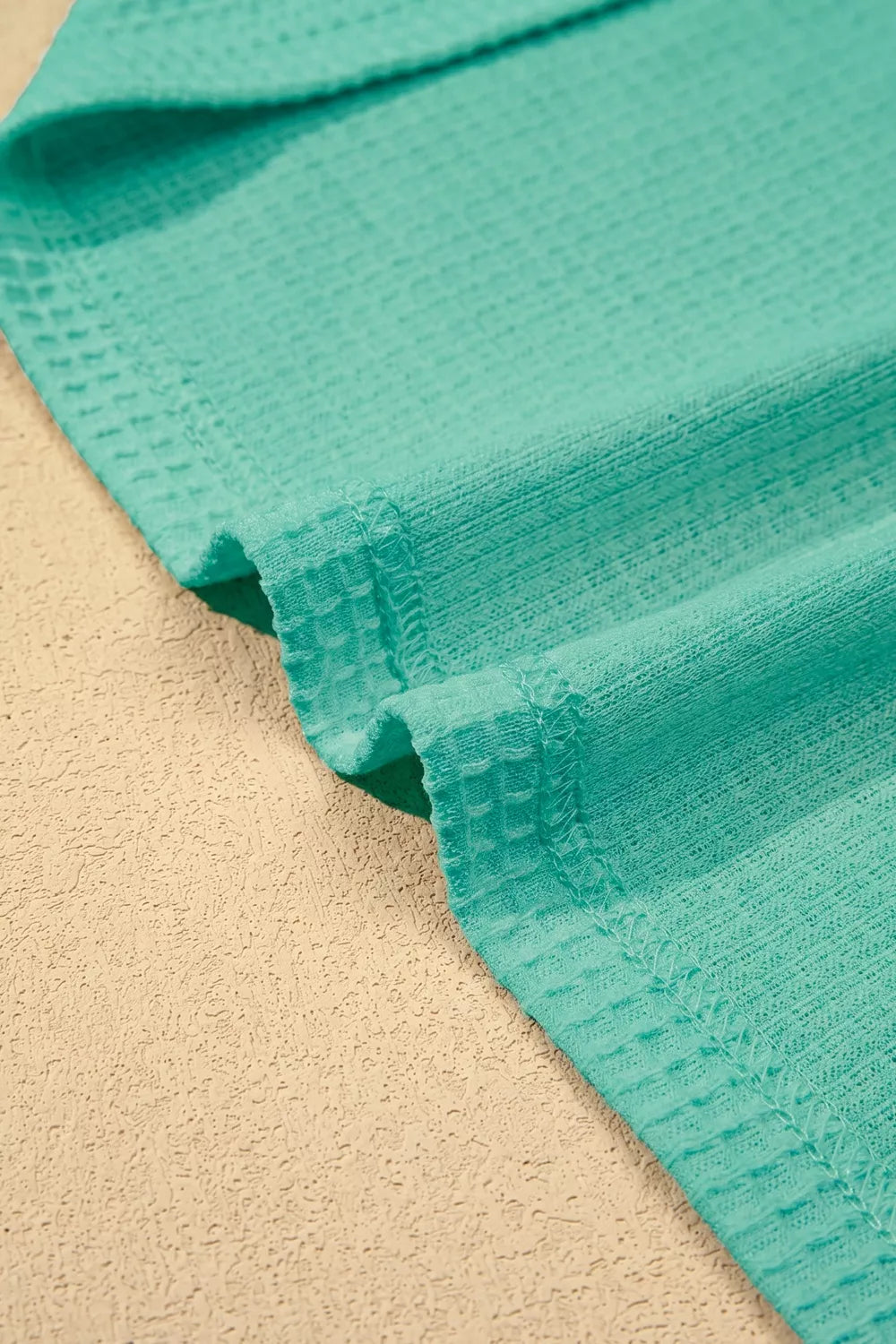 Teal waffle knit shirt with lace trim detail.