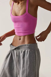 Pink ribbed active tank top with a curved hem and square neckline.