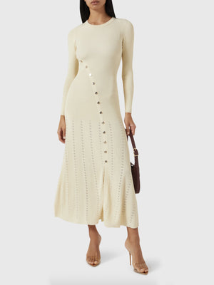 Ribbed knit maxi dress in cream with decorative buttons and open knit detail.