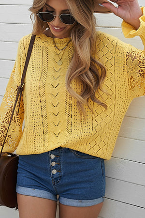 Yellow openwork knit sweater with lace sleeves and diamond pattern detail.