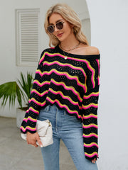Black crochet crop sweater with pink and yellow zigzag stripes, off-the-shoulder neckline.