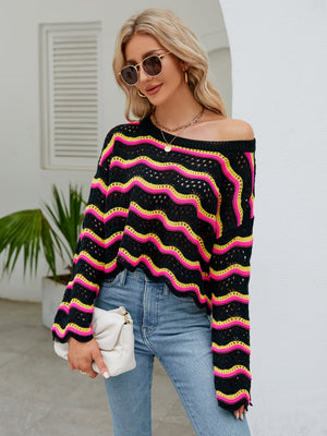 Black crochet crop sweater with pink and yellow zigzag stripes, off-the-shoulder neckline.