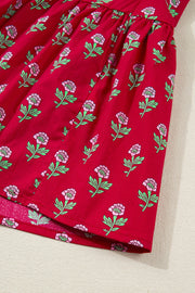 Red cotton mini dress with pink floral print and green leaves.