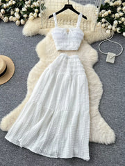 White ruched crop top and maxi skirt set with tie detail.
