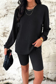 Black ribbed knit loungewear set with long sleeve top and bike shorts.