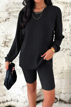 Black ribbed knit loungewear set with long sleeve top and bike shorts.