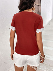 Burgundy waffle knit henley with white lace trim on short sleeves.